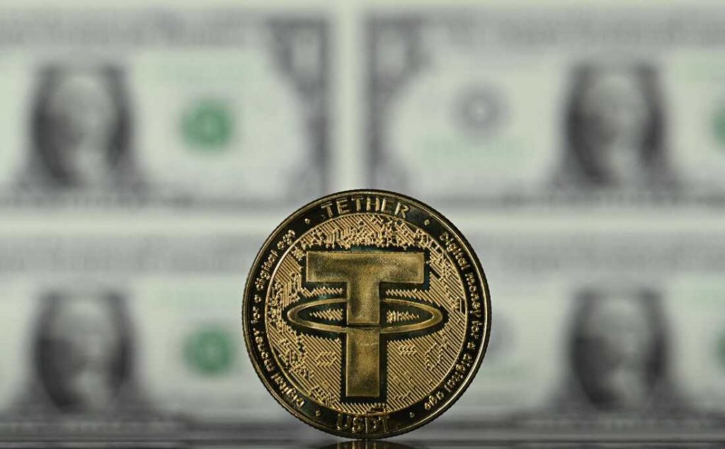 เหรียญทองคำจำลองสัญลักษณ์คริปโต Tether USDT วางบนกองธนบัตรดอลลาร์สหรัฐ  Stablecoin คืออะไร